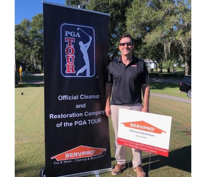 Male restoration employee at a golf event