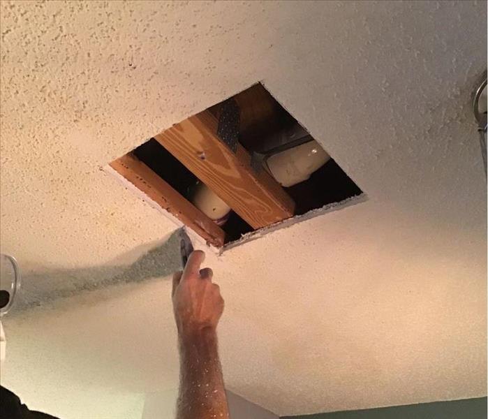 a square hole cut in the ceiling
